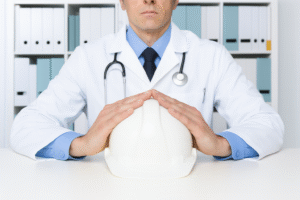 Doctor with stethoscope holding a safety helmet, symbolizing occupational health assessments and workplace safety.