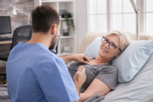 Healthcare provider examining an elderly patient during a sick visit for acute care in Garland, Texas.
