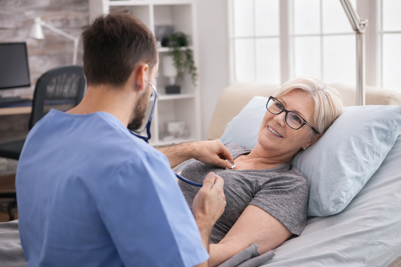 Healthcare provider examining an elderly patient during a sick visit for acute care in Garland, Texas.