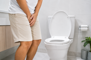 Person holding bladder wondering why do I need to pee so often